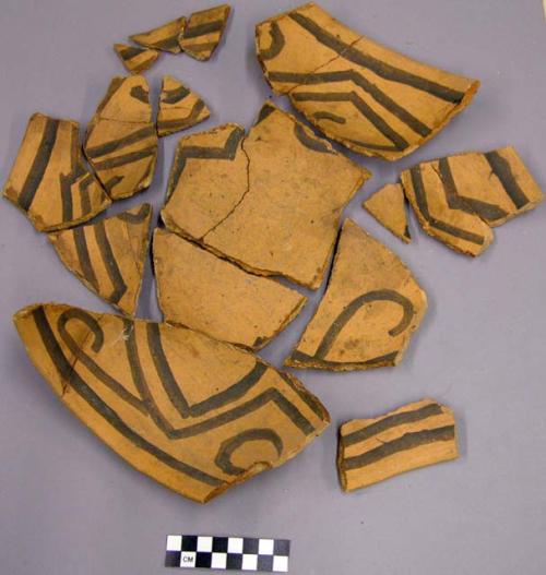 Sherds of black on orange bowl with interior linear wall pattern