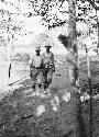 Fred Johnson and Doug Byers walking through woods