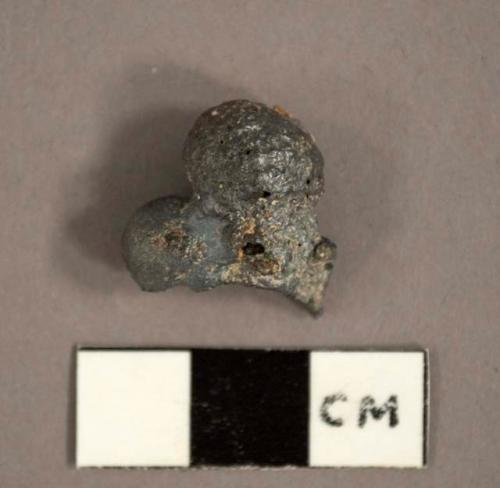 Shiny lead-colored slag fragments