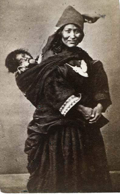 Woman carrying child on her back, standing