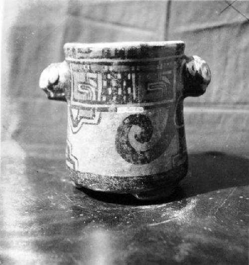 Painted ceramic vase with two large, animal-effigy handles