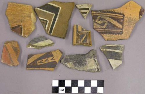 Polychrome sherds with geometric designs and bands on one side