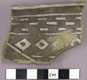 Sherd with black on white interior geometric designs