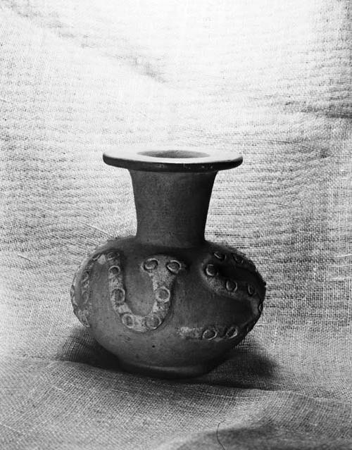 White on red jar with serpent modelled on body, flaring neck and ring base