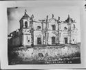 Two men siiting on steps of church in Guatemala