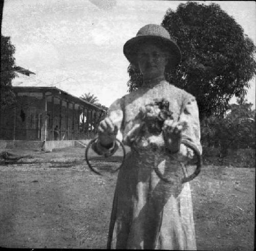 Woman holding neck rings dredged from Logone River, Cameroon