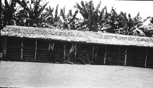 People in front of hut