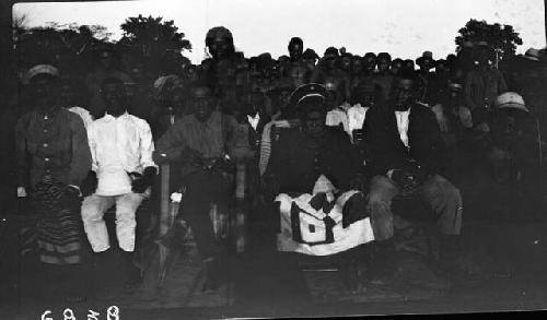 Group of men gathered around Chief and Grand Chief