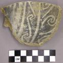 Black on white sherd with wave patterns and handle fragment