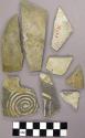 Mostly plain sherds, three with exterior black on white designs