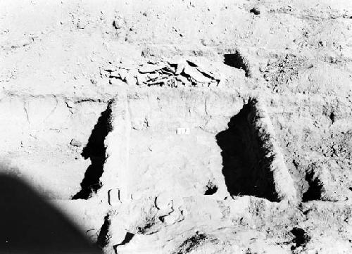 Floor below flag and adobe floor in room 17