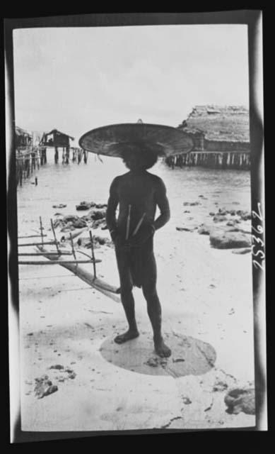 Man in front of canoe