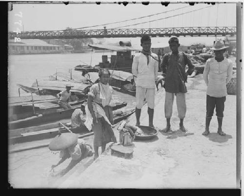 Group of people near boats in the river