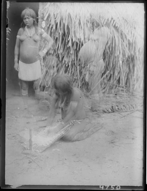 Girl grating cassava