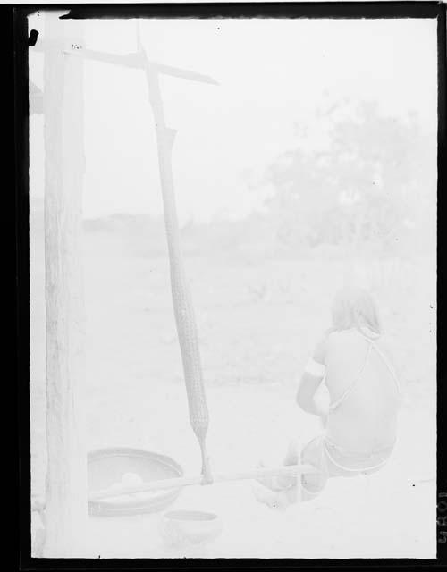 Woman straining wet cassava