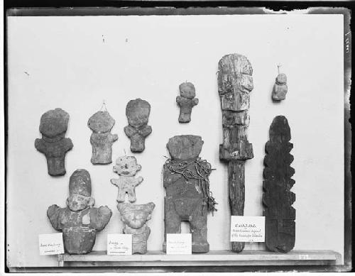 Eleven carved idols and figures on display