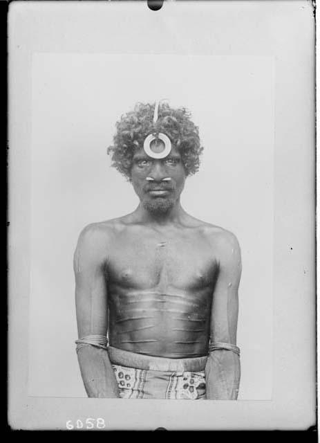 Man with nose plug and forehead ornament