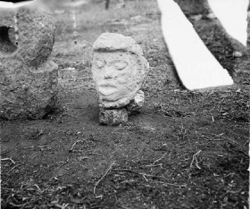 Stone human head in mouth of bird, Str. Q-126