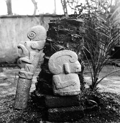 Sculpured stone human figure and jaguar pedestal sculpture