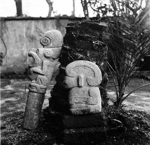 Sculpured stone human figure and jaguar pedestal sculpture