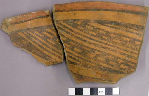 Portions of polychrome red bowl with interior diagonal line patterns