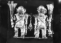 Tumbaga pendant of two warriors carrying clubs