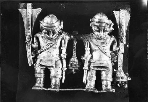 Tumbaga pendant of two warriors carrying clubs