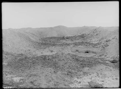 House foundation of square deposit filled with slag rocks