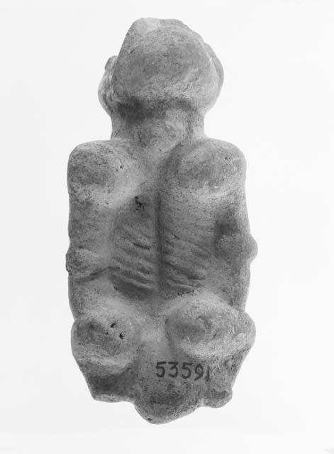 Human male figure in clay or soft stone painted red