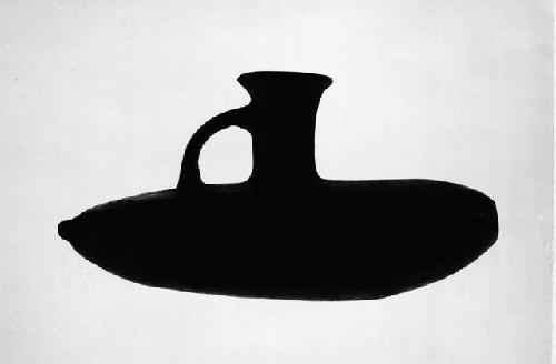 Banana shaped vessel with spout and handle, linear design