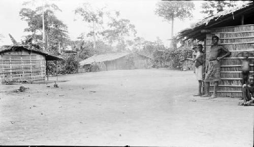 People standing beside hut