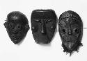 Three wooden masks