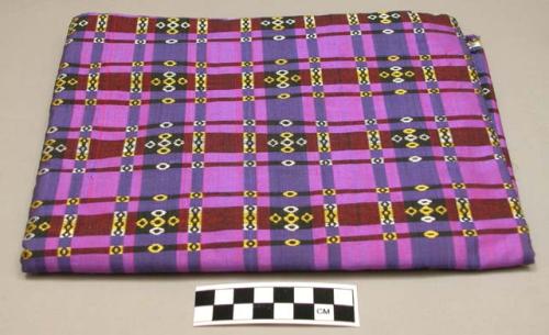 Fabric for woman's longyi; purple and indigo plaid with yellow and white designs