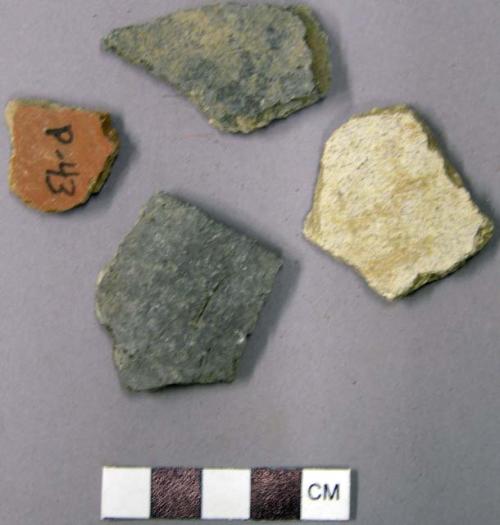 Ceramic unslipped plainware potsherd and one stone chip