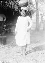 Native woman carrying vessel on head