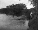 Men standing on riverbank at Cocle
