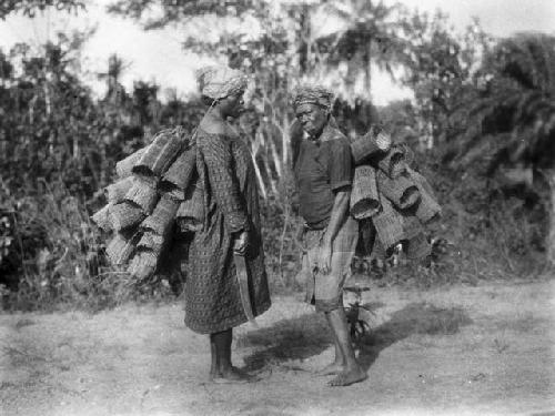 Women on the way to stream to set shrimp and crab trap