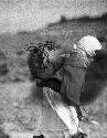 Woman carrying jar on back