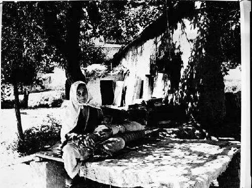 Older woman with head covering holding baby