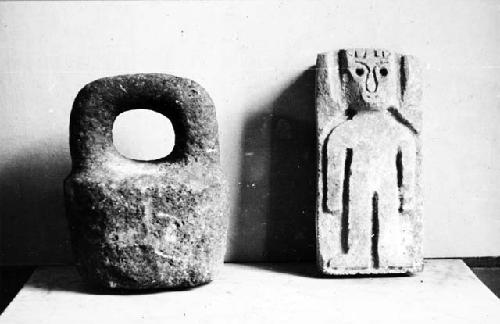 Weight with handle and carved limestone figure