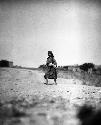 Woman walking along the road