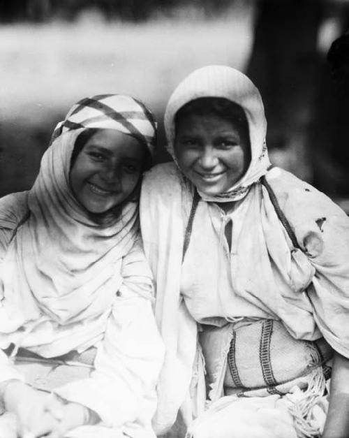 Two girls wearing traditional clothing