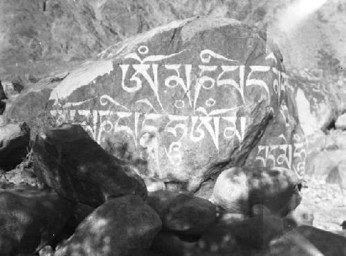 Boulder with "Om Mani Padme Hum" written in Tibetan