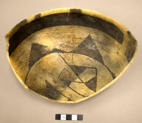 Part of black-on-yellow pottery bowl