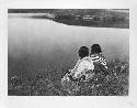 "An Idle Hour -- Piegan," photograph of Native Americans seated by river