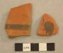 2 fragments of pottery - red ware with black painted design