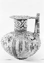 Polychrome jar with spout handle, flaring neck, ring base from Grave 5