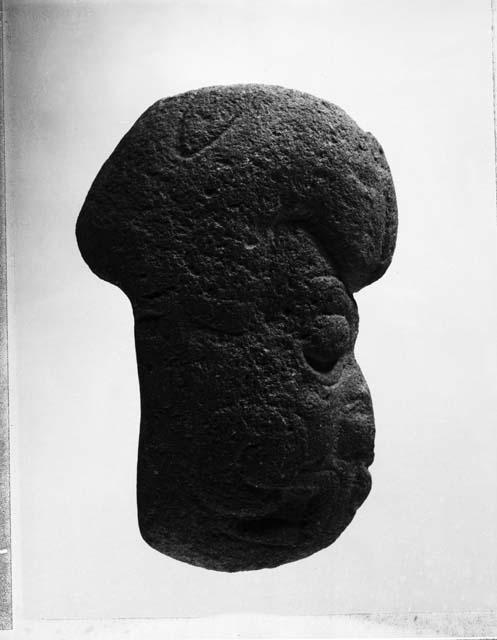 Carved stone head, side view