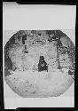 Hopi woman standing and holding a basket