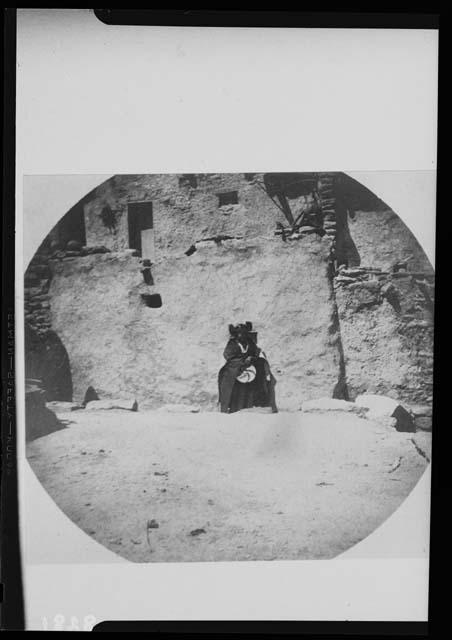 Hopi woman standing and holding a basket